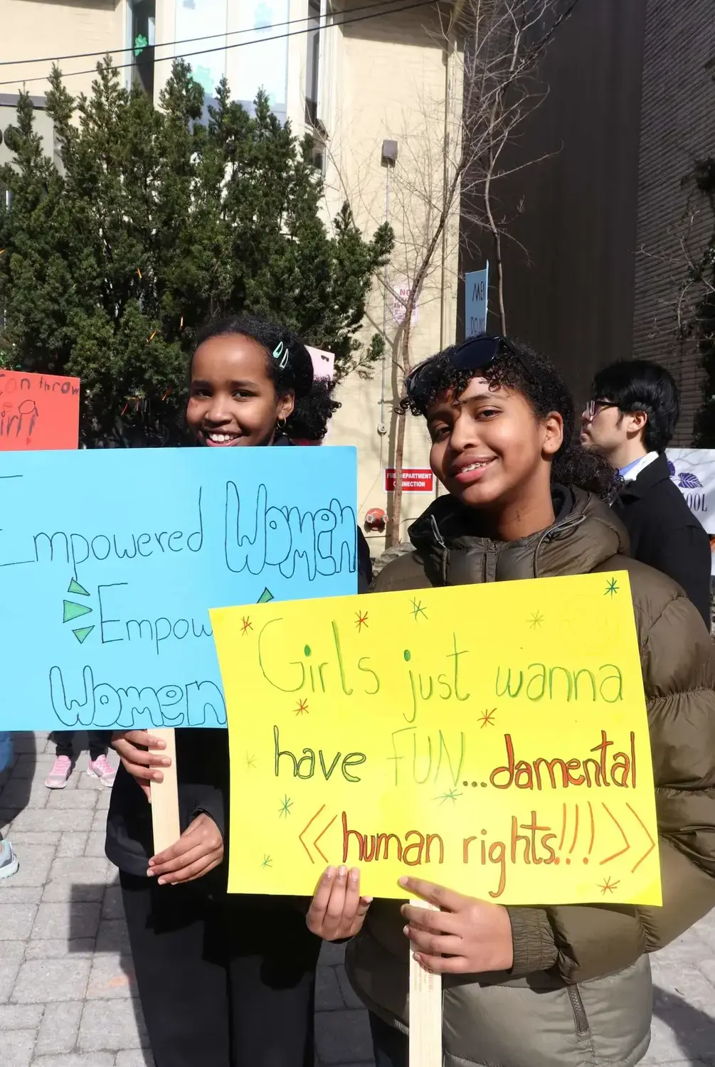 Students holding DIY signs in celebration of OSOS Women's Day 2025